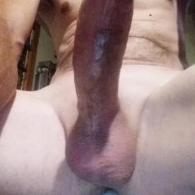 Hard cock and balls sitting on the bed - Rate My Wand